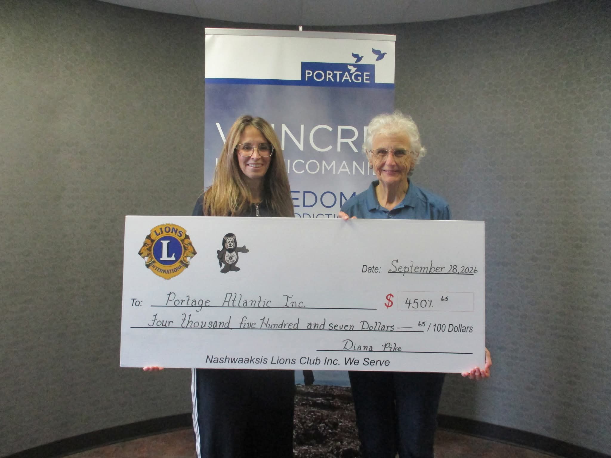 President Diana Pike presenting a $4,507.65 cheque to Carol Tracey of Portage Atlantic